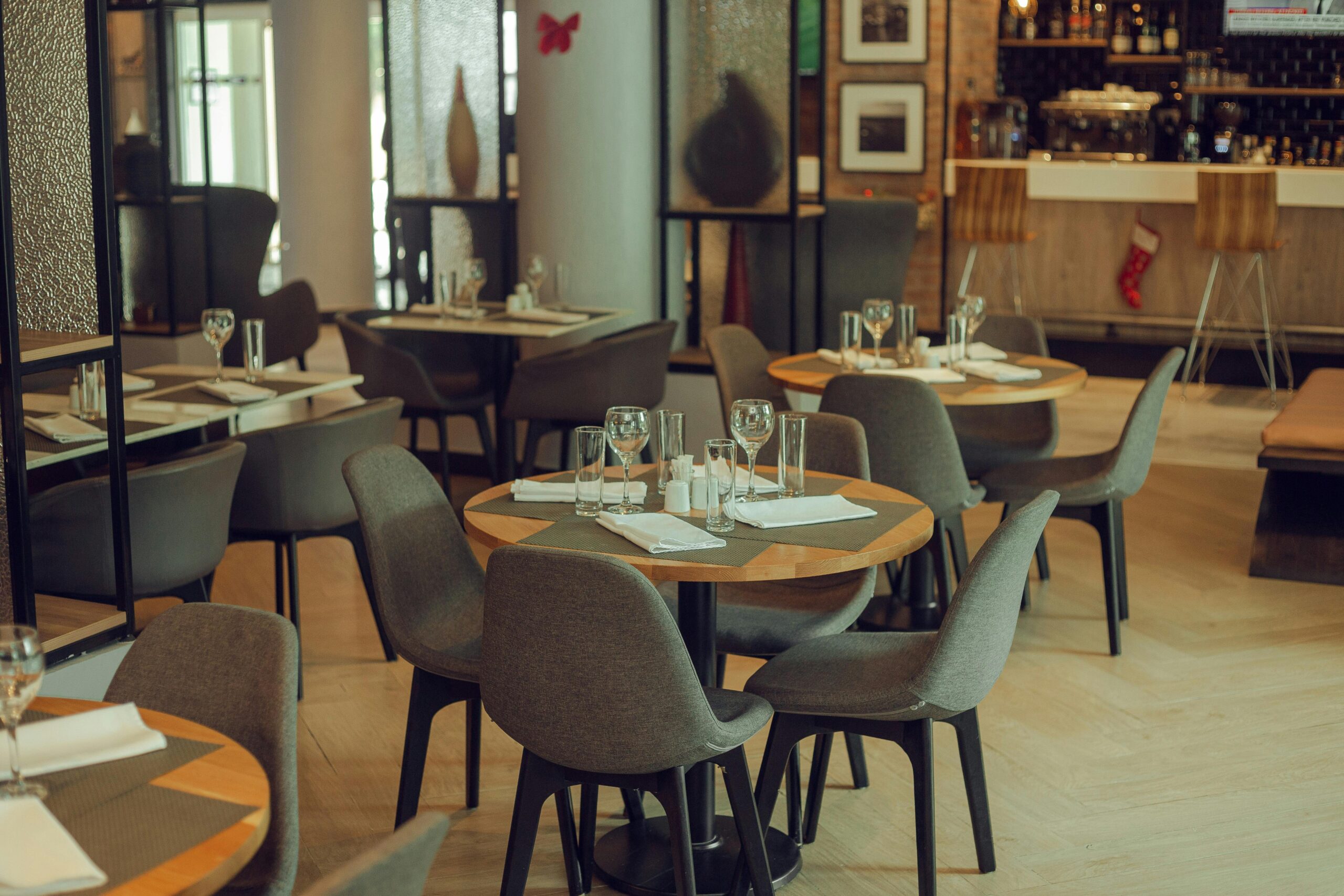 Warm and inviting modern restaurant setting with neatly arranged tables and chairs.